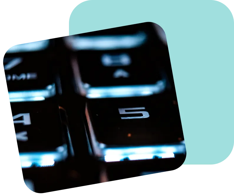 Close-up of an illuminated computer keyboard number pad with the number 5 in focus, symbolizing digital connectivity and secure data entry