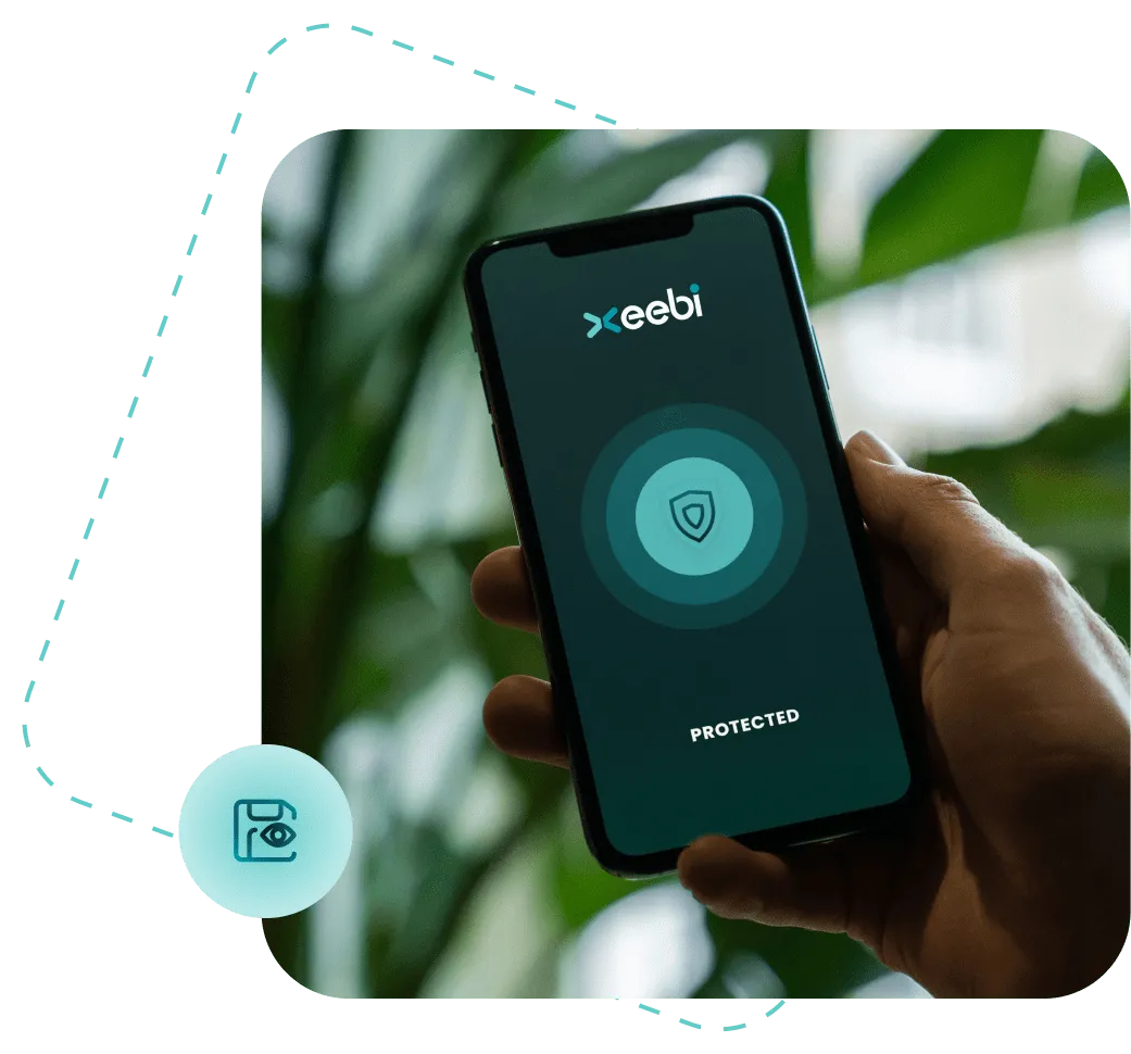 Hand holding a smartphone displaying the Xeebi app with a security shield icon and the word ‘Protected’ on screen, symbolizing mobile cybersecurity and two-factor authentication